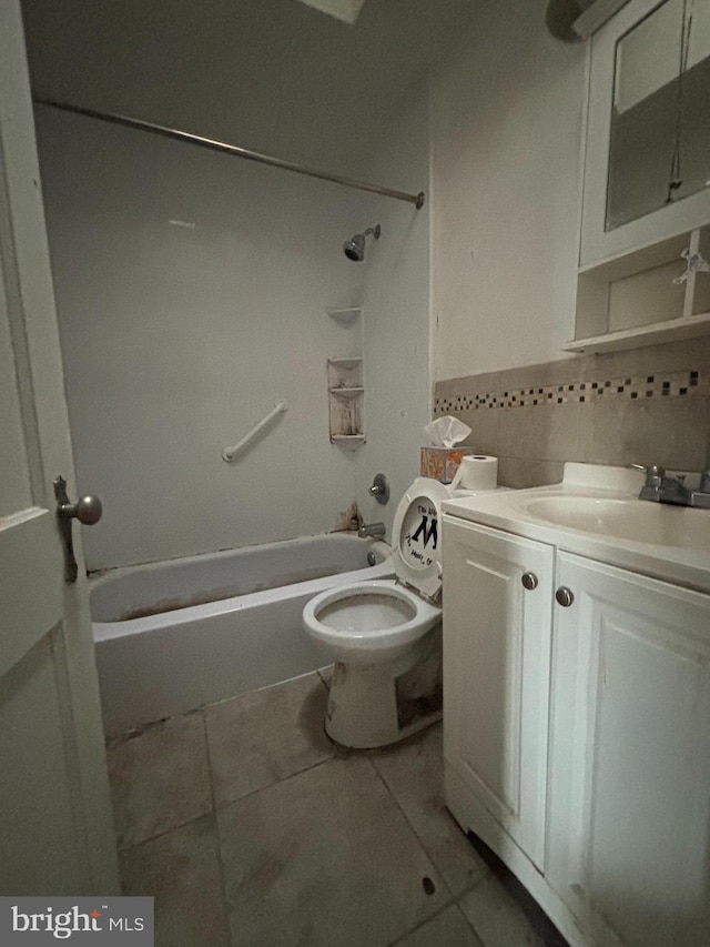 bathroom with shower / bathtub combination, backsplash, toilet, vanity, and tile patterned floors