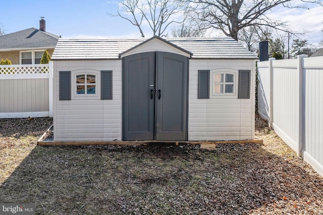 view of shed with a fenced backyard