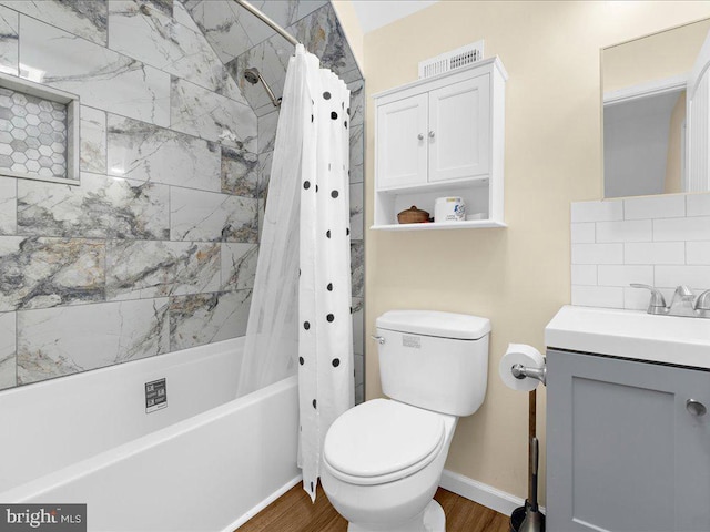 bathroom with tasteful backsplash, toilet, wood finished floors, shower / bathtub combination with curtain, and vanity