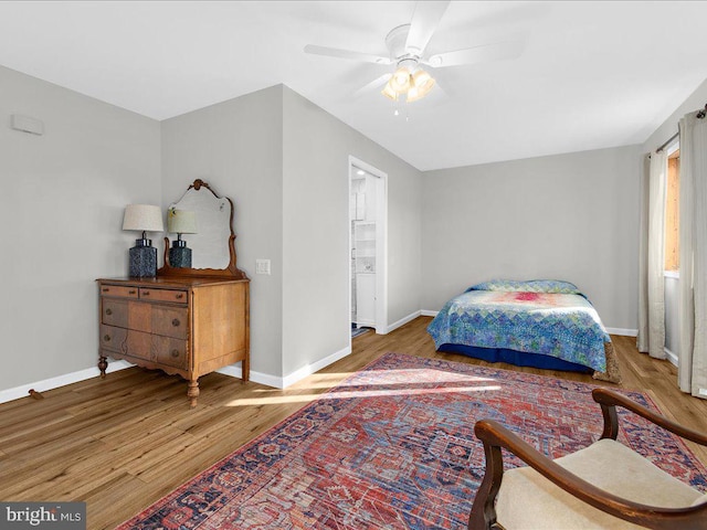 bedroom featuring ceiling fan, baseboards, and wood finished floors