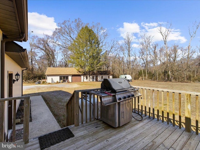 wooden deck featuring a lawn