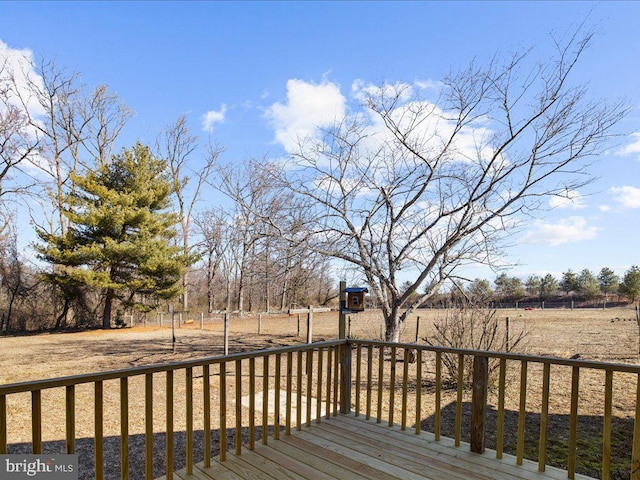 wooden deck with a rural view