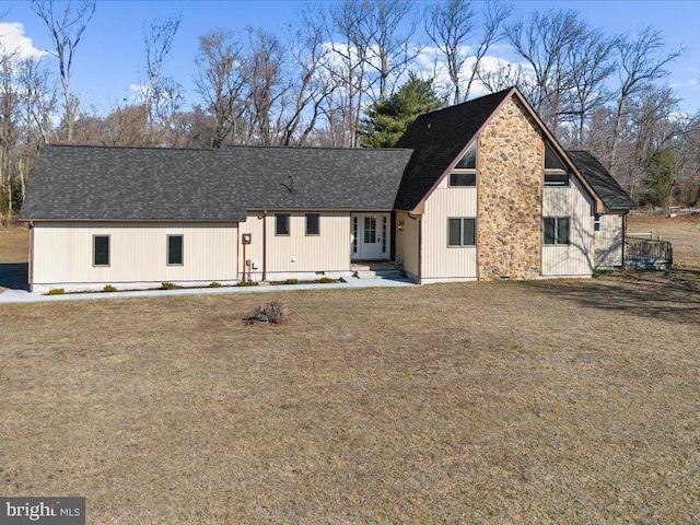 view of front of house with crawl space, a shingled roof, and a front lawn