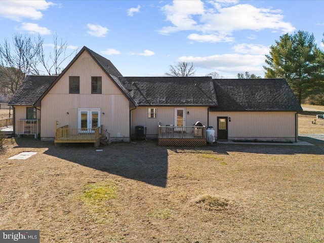 rear view of house featuring french doors, roof with shingles, cooling unit, and a wooden deck