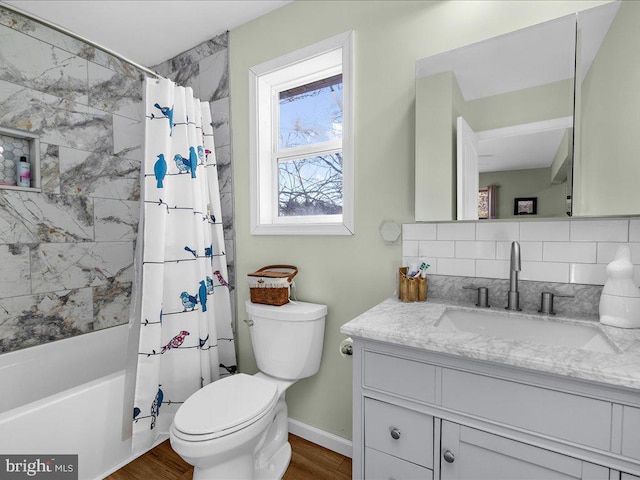 full bath featuring toilet, wood finished floors, backsplash, and vanity