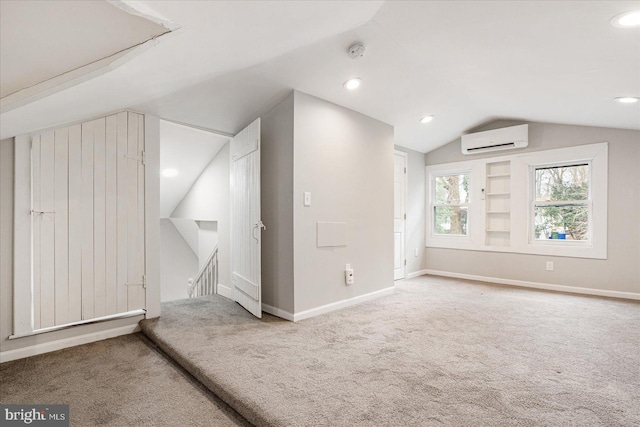 bonus room with carpet, a wall unit AC, vaulted ceiling, and baseboards