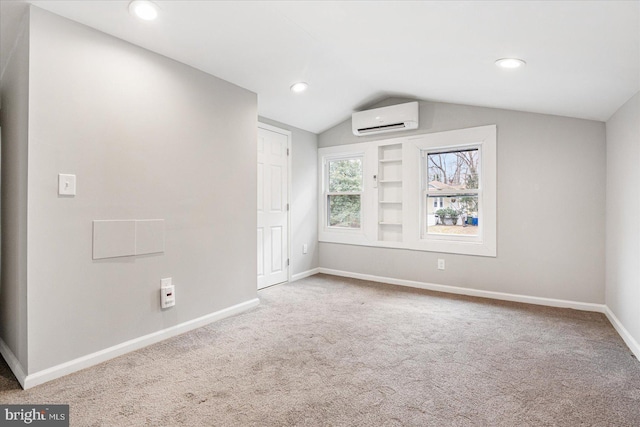 spare room featuring baseboards, lofted ceiling, a wall mounted air conditioner, carpet, and recessed lighting