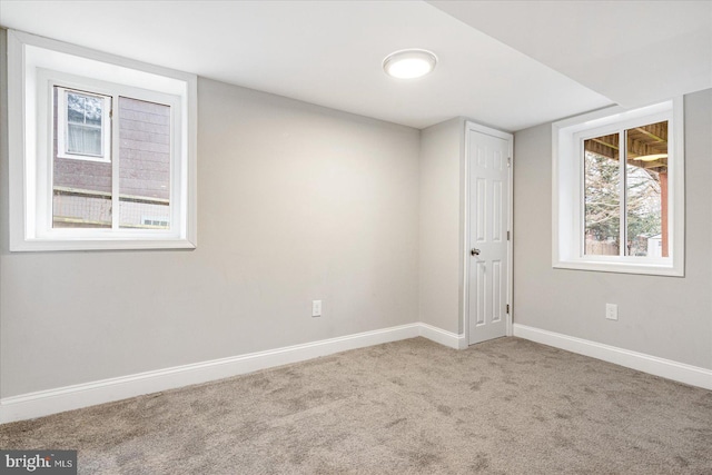 unfurnished room with carpet floors and baseboards