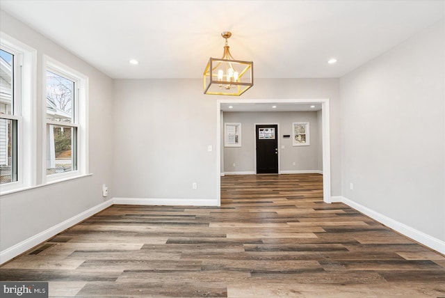 unfurnished dining area with baseboards, visible vents, wood finished floors, and recessed lighting