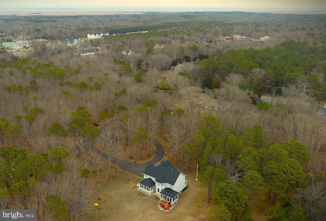 birds eye view of property featuring a wooded view