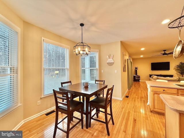 dining room with recessed lighting, visible vents, light wood-style flooring, and baseboards