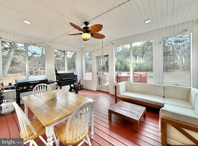 sunroom with a ceiling fan and wooden ceiling