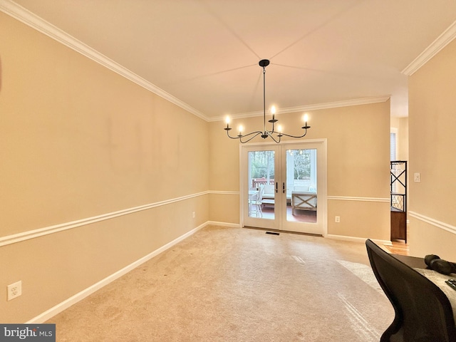 unfurnished dining area with crown molding, french doors, an inviting chandelier, and light colored carpet