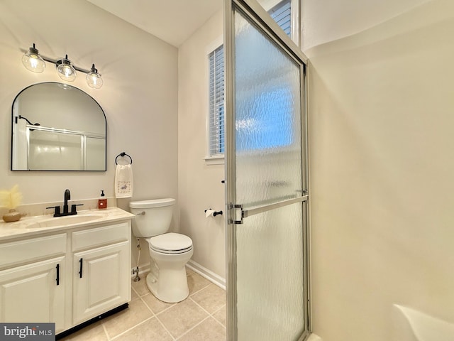 bathroom featuring baseboards, toilet, tile patterned flooring, an enclosed shower, and vanity