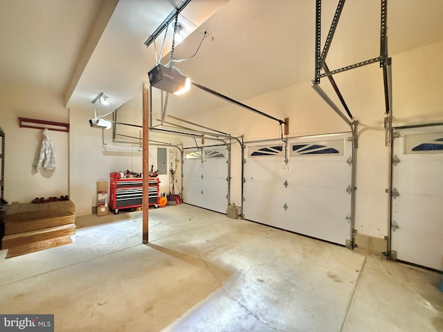 garage featuring electric panel and a garage door opener