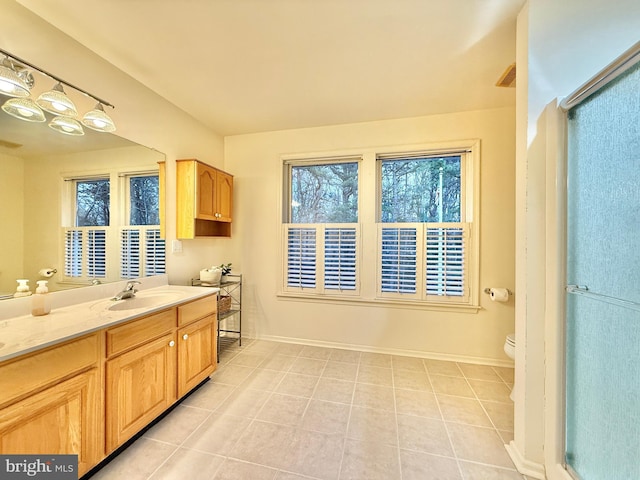 full bath featuring baseboards, vanity, toilet, and tile patterned floors