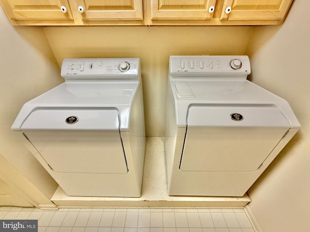 laundry room featuring independent washer and dryer and cabinet space