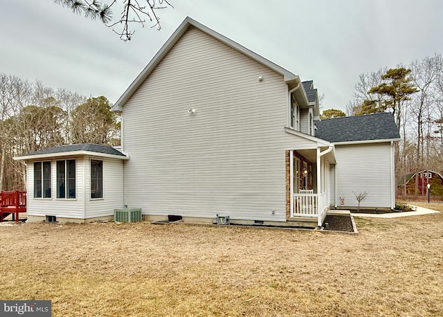 back of house featuring crawl space, a yard, and central air condition unit