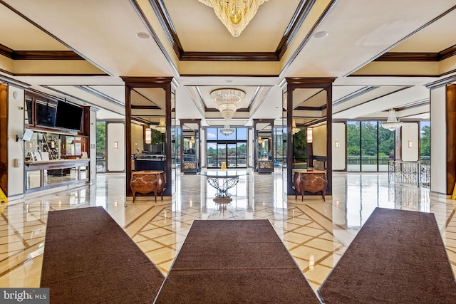 foyer with an inviting chandelier and ornamental molding