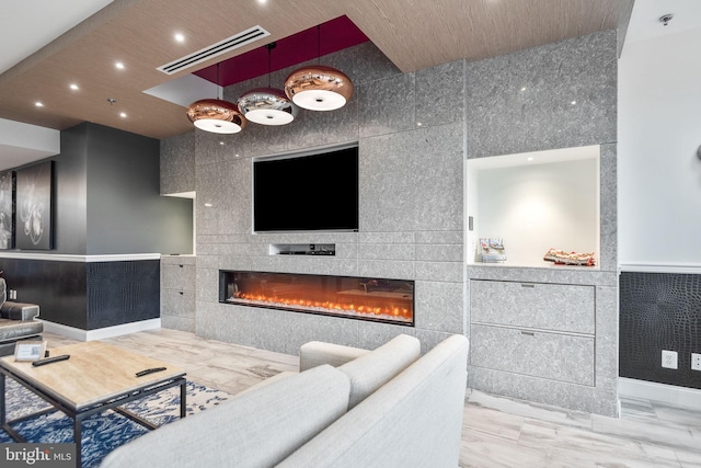 living room with visible vents, recessed lighting, tile walls, wainscoting, and a tile fireplace