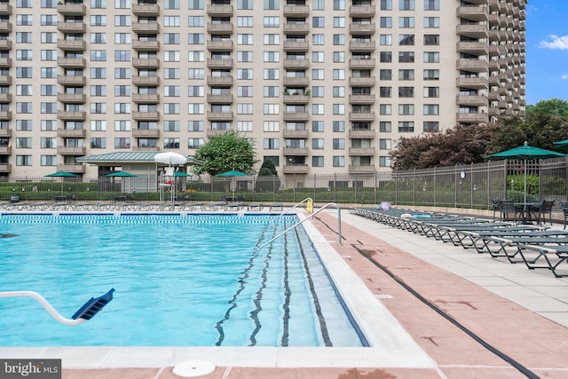 view of pool featuring fence