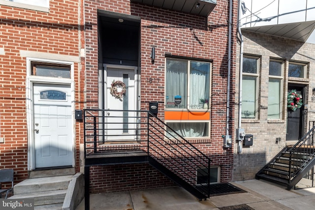 property entrance featuring brick siding