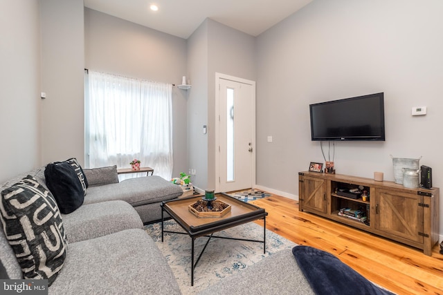 living room featuring recessed lighting, wood finished floors, and baseboards