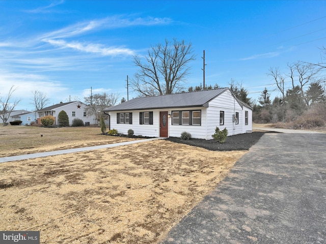 ranch-style house featuring metal roof