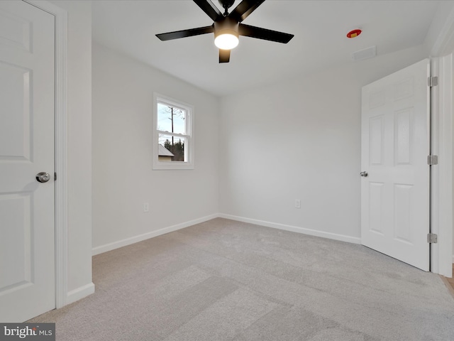 unfurnished bedroom featuring ceiling fan, carpet flooring, visible vents, and baseboards