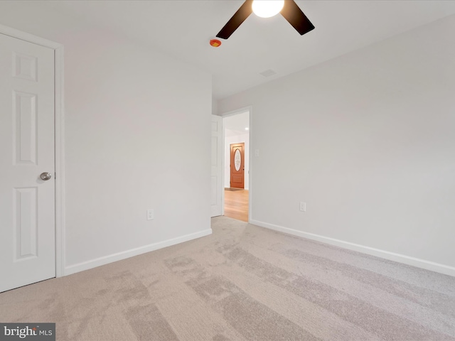 unfurnished bedroom featuring carpet floors, baseboards, and a ceiling fan