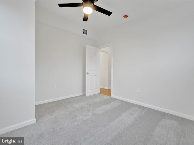 unfurnished bedroom featuring a ceiling fan, baseboards, visible vents, and carpet flooring