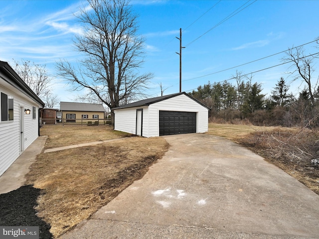 detached garage featuring fence