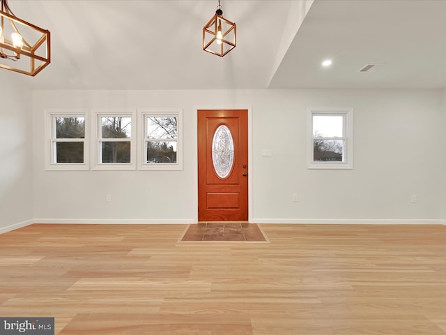 entryway featuring light wood-style flooring, visible vents, and baseboards