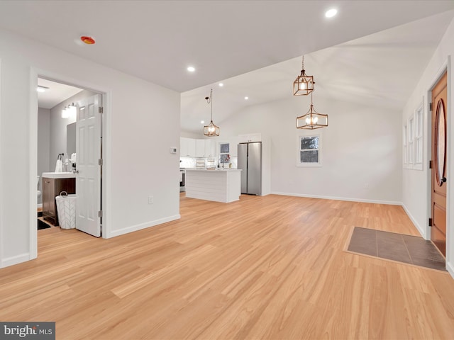 unfurnished living room featuring baseboards, lofted ceiling, an inviting chandelier, light wood-style floors, and recessed lighting