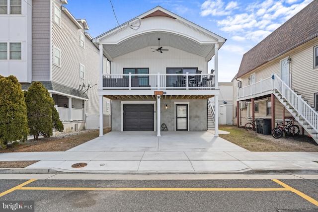 view of front of home featuring stairs, driveway, ceiling fan, and a garage