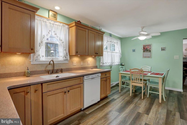 kitchen with dark wood finished floors, dishwasher, ceiling fan, light countertops, and a sink