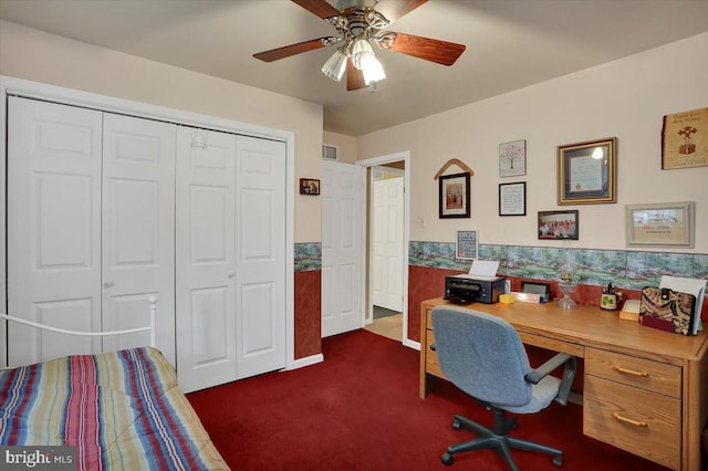 office featuring ceiling fan, visible vents, and dark colored carpet