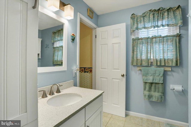 bathroom featuring baseboards, vanity, and tile patterned floors