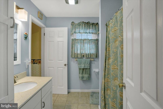 full bath featuring baseboards, vanity, and tile patterned floors