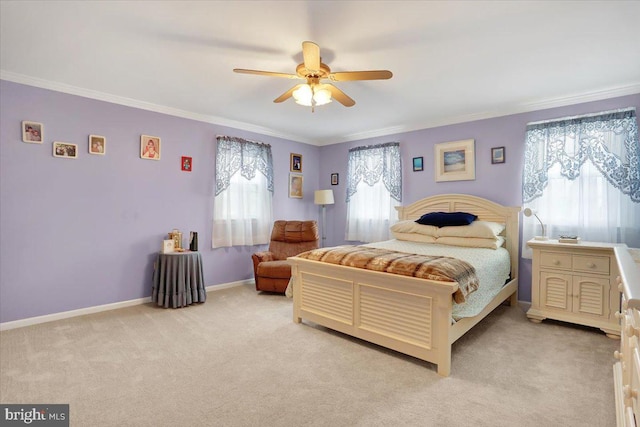 bedroom with light carpet, a ceiling fan, baseboards, and crown molding