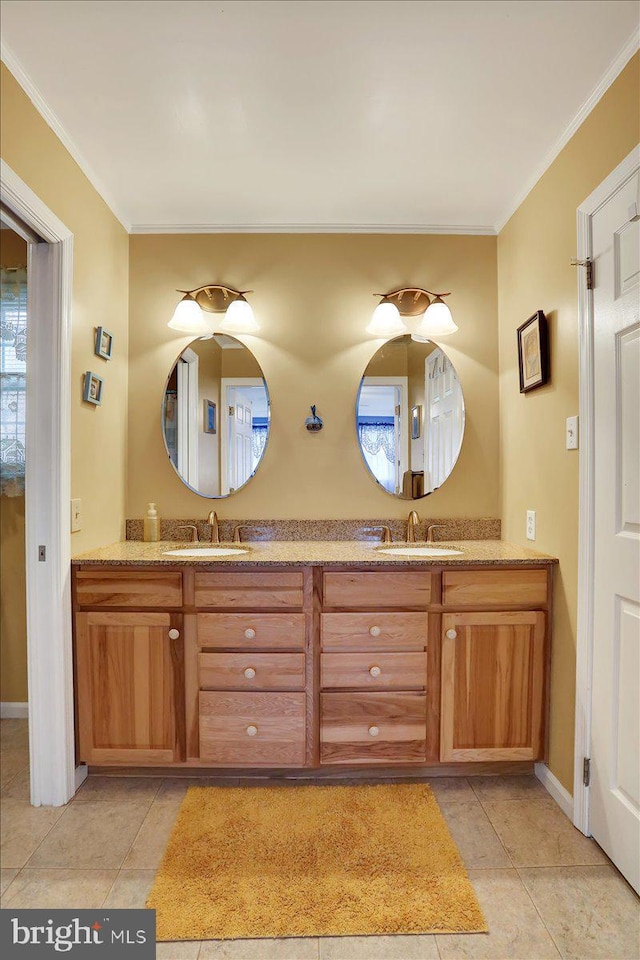 full bath with double vanity, ornamental molding, and a sink