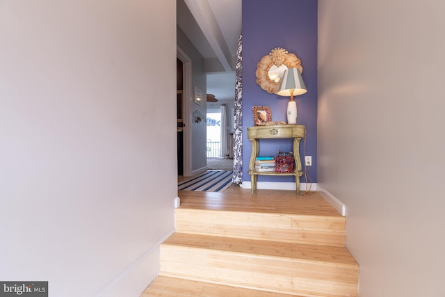 stairs featuring baseboards and wood finished floors