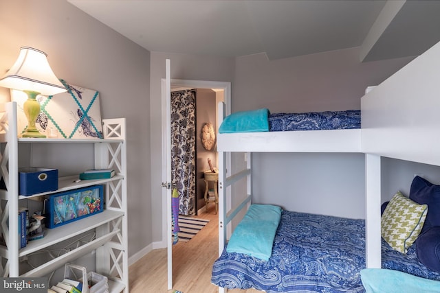 bedroom with wood finished floors and baseboards