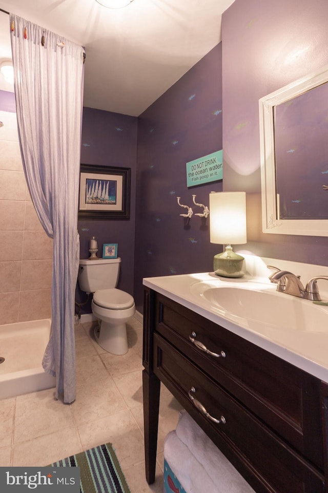 bathroom with tile patterned floors, vanity, toilet, and a shower stall