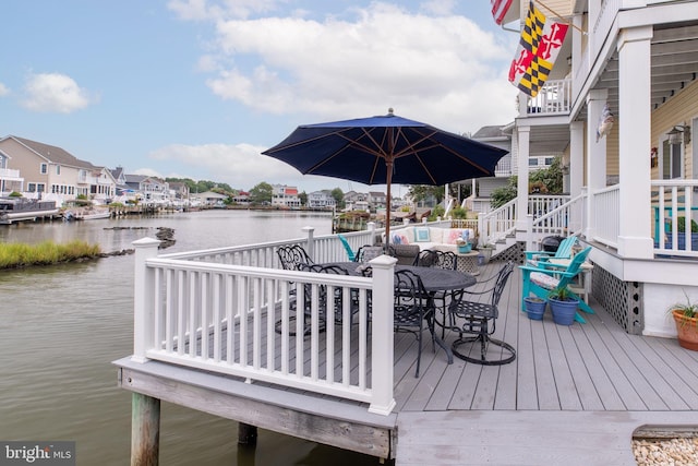 dock area featuring a water view and a residential view