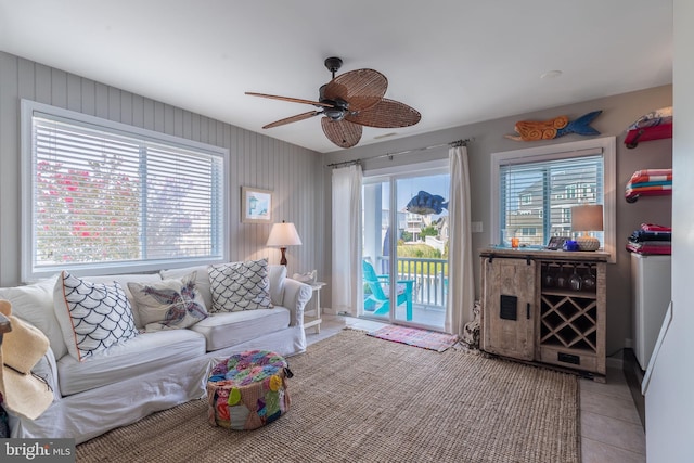 living area featuring light tile patterned flooring and ceiling fan