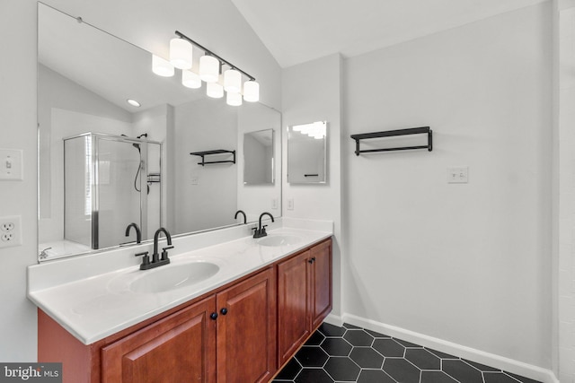 bathroom with lofted ceiling, double vanity, a sink, and a shower stall