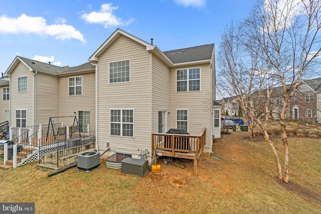 back of house featuring a lawn, a deck, and central air condition unit