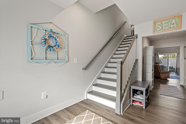 stairs featuring baseboards and wood finished floors