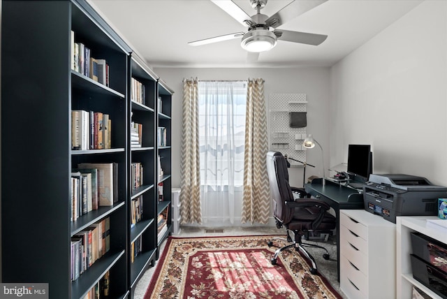 home office with visible vents and a ceiling fan